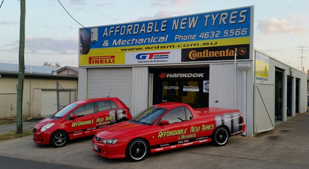 Business cars parked in front of mechanical shop