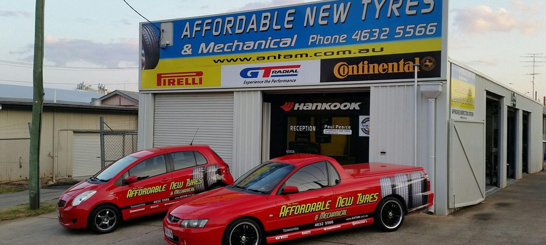 Business cars parked in front of mechanical shop