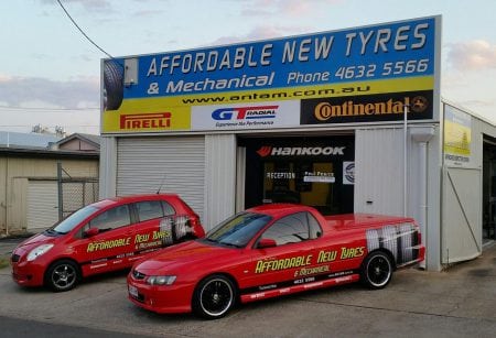 Business cars parked in front of mechanical shop