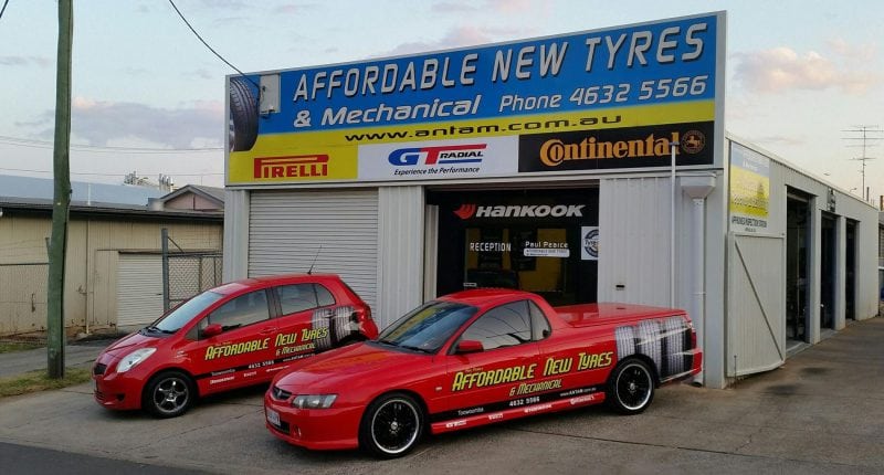 Business cars parked in front of mechanical shop