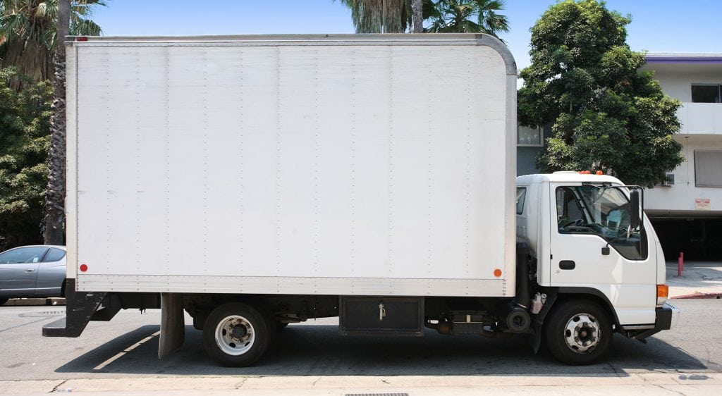 White delivery truck in suburban street