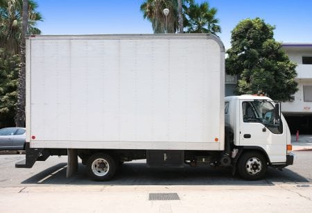 White delivery truck in suburban street