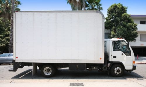 White delivery truck in suburban street