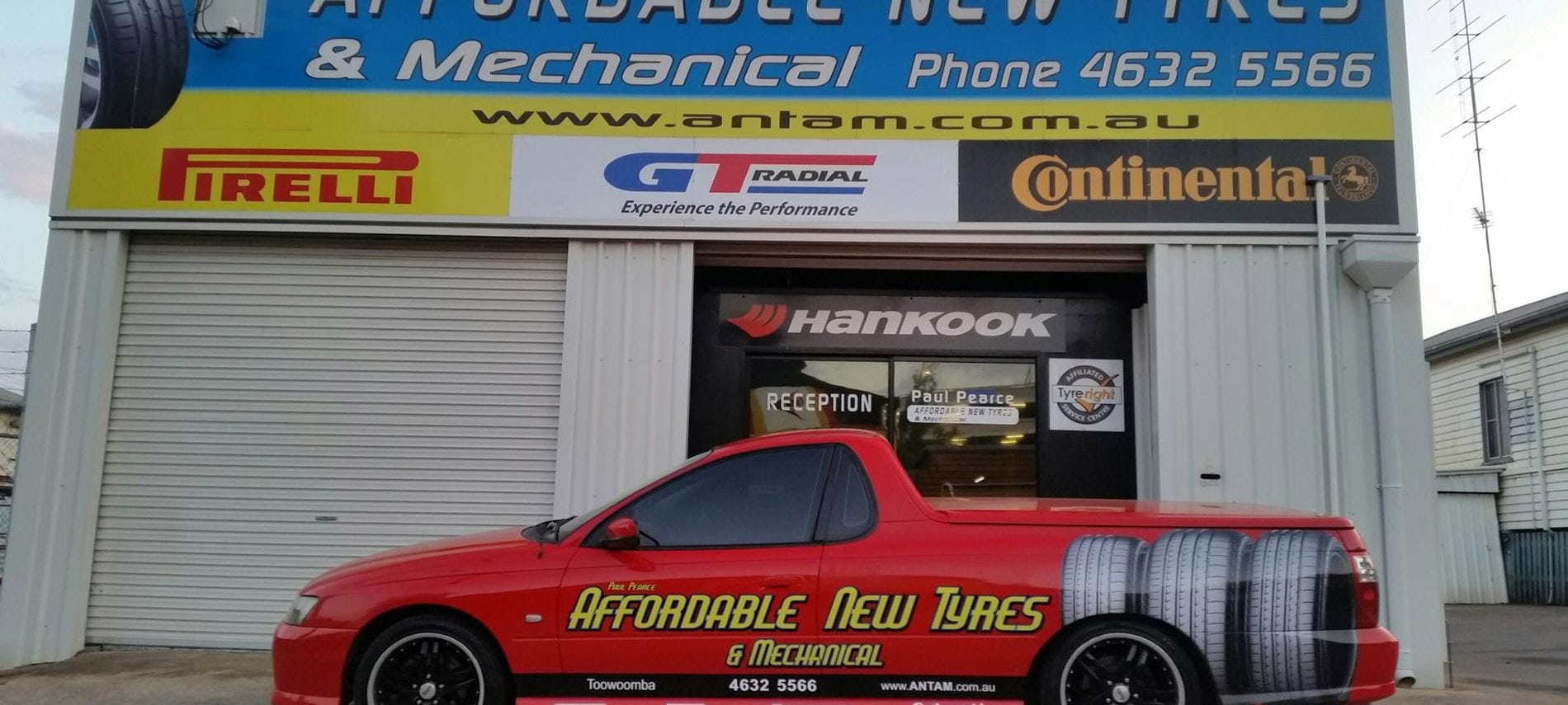 Business car parked in front of a mechanical shop