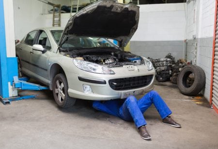 Mechanic servicing car